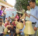 Facilitator demonstrating a natural fibre basket to participants