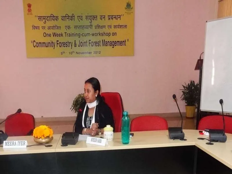Speaker presenting at a community forestry and development workshop