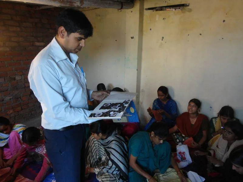 Facilitator reviewing programme materials with participants