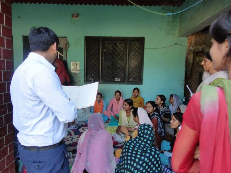 Facilitator speaking with women during an Empower Society programme visit