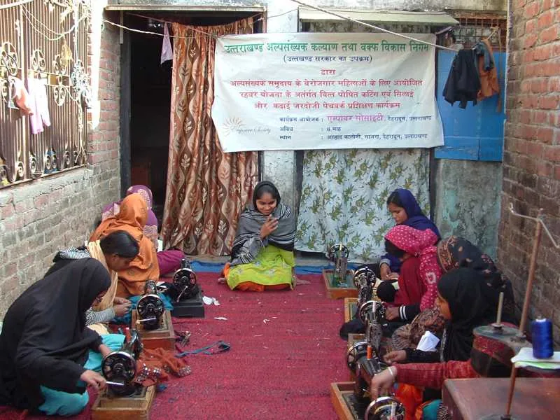 Women practising sewing during a skills development session